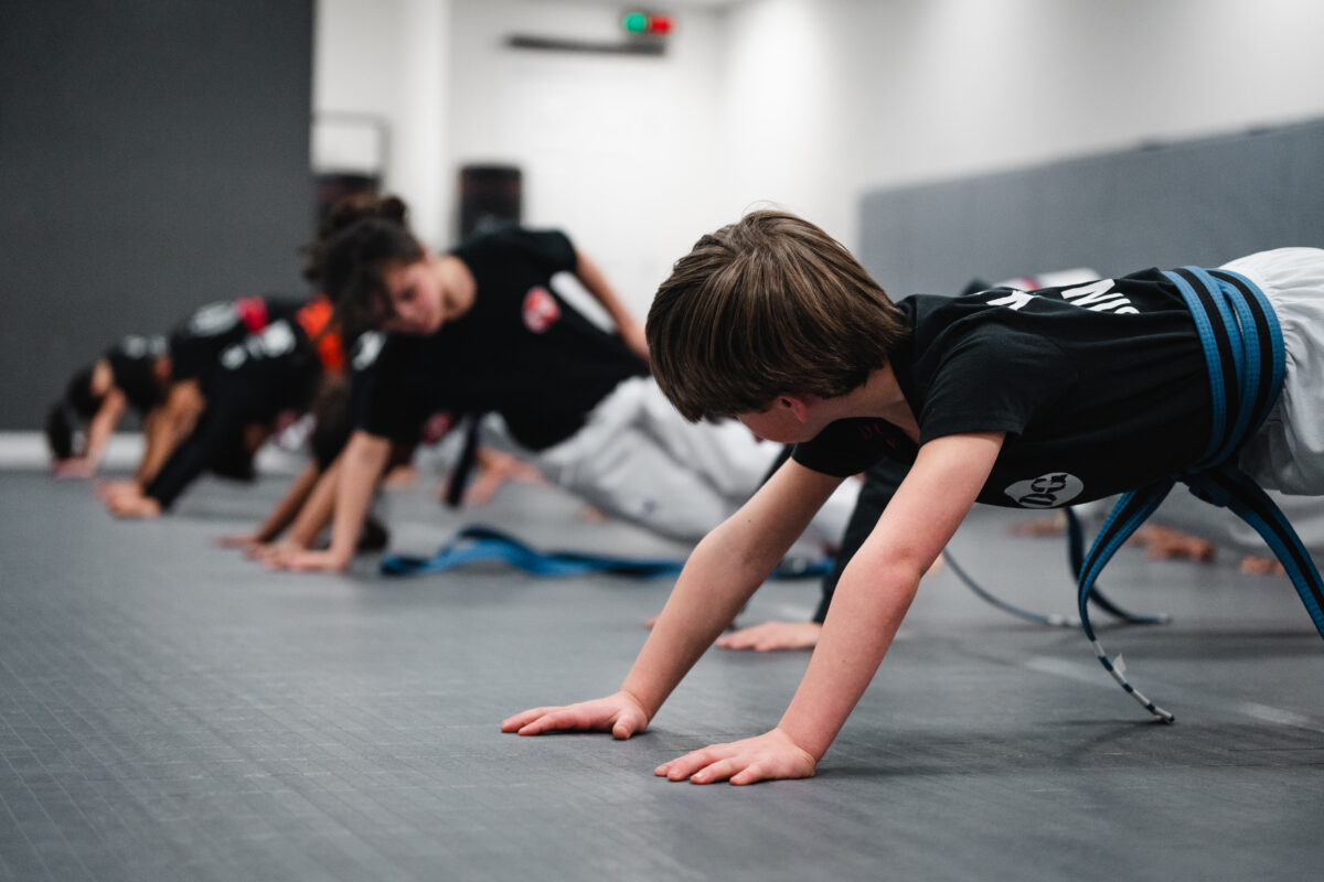 Kids Doing Pushups in a Taekwondo Class