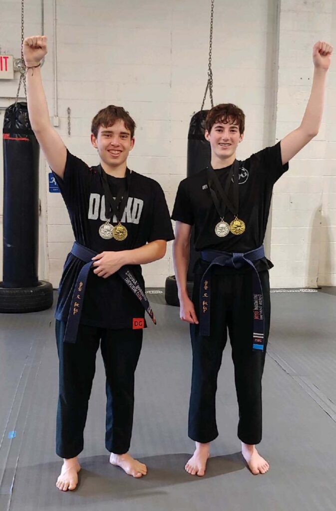 Downingtown Taekwondo Students show off their medals after a sparring tournament